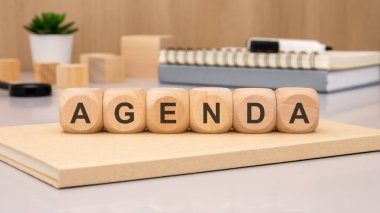 Çağdaş bir çalışma alanında AGENDA 'yı yaratıcı bir şekilde heceleyen ahşap blokların şık ve çekici bir düzeni.