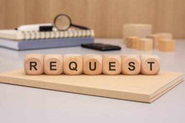 Bu, profesyonel bir ofis ortamında ahşap bloklar kullanılarak gösterilen istek kavramının bir görüntüsüdür.