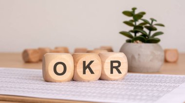 OKR hedefleri ve anahtar sonuç sembolü. Sulu bitkilerle dolu bir arka plan. İş ve OKR kavramı