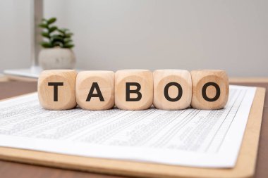 wooden blocks forming the word TABOO placed on a financial spreadsheet. concept of forbidden, sensitive, or restricted financial subjects, hidden rules, or controversial issues.