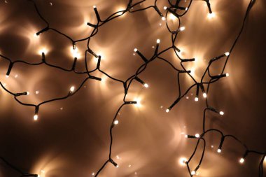 String lights ambience. Garlands on a reflective background clipart