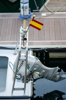 Dış teknesi Honda motoru ve İspanyol bayrağıyla birlikte modern bir marina rıhtımında, deniz ve turizm kavramları için ideal, boş zaman ve seyahat titreşimleri iletiliyor..