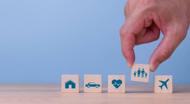 Wooden blocks with icons of various types of insurance. Life insurance concept.