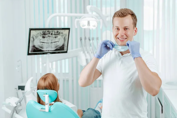 stock image Doctor dentist smiling without medical mask in dental clinic on backdrop with medical equipment, x-ray dental and patient. Smile healthy teeth concept