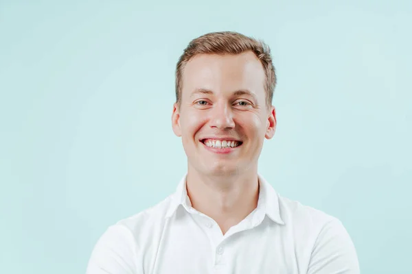 stock image Young man smiling with natural white teeth in dental clinic on light background. Smile healthy teeth concept