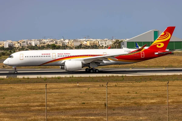 stock image Luqa, Malta - July 8, 2023: Airbus Industrie Airbus A350-941 (REG: F-WJKM) still in Hainan Livery, departing to Dublin to be painted in Fiji Airways (REG: DQ-FAN).