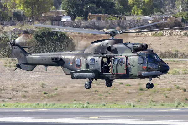 stock image Luqa, Malta - September 25, 2023: Dutch Air Force Eurocopter AS-532U2 Cougar Mk2 (REG: S-419) departing runway 31.