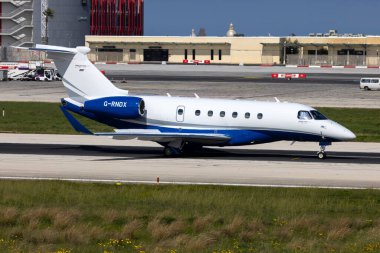 Luqa, Malta - 18 Mart 2024: Özel Embraer EMB-550 Praetor 600 (REG: G-RNDX) pistin orta uzunluğundan kalkıyor.