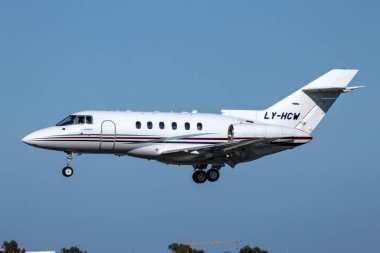 Luqa, Malta - March 6, 2024: Charter Jets Raytheon Hawker 800XP (REG: LY-HCW) on finals runway 31 in the afternoon. clipart