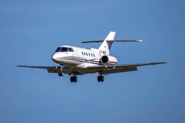 Luqa, Malta - March 6, 2024: Charter Jets Raytheon Hawker 800XP (REG: LY-HCW) on finals runway 31 in the afternoon. clipart