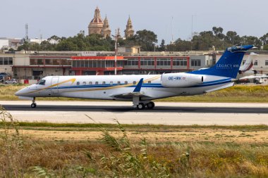 Luqa, Malta - April 15, 2024: Europ-Star Aircraft GmbH Embraer Legacy 600 (EMB-135BJ) (REG: OE-IRK) landing runway 13. clipart