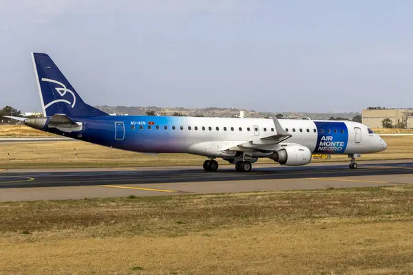 stock image Luqa, Malta - May 1, 2024: Air Montenegro Embraer 195LR (ERJ-190-200LR) (REG: 4O-AOB) vacating the runway to the apron after landing.