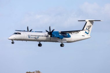 Luqa, Malta - September 14, 2024: Universal Air Bombardier DHC-8-402 Q400 (Reg.: 9H-SWW) landing runway 31. clipart