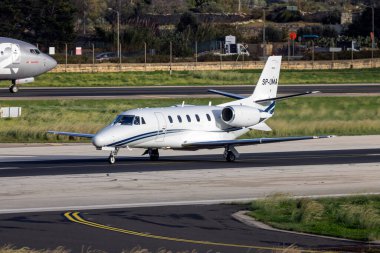 Luqa, Malta - December 5, 2024: Cessna 560XL Citation XLS (REG: SP-UMA) taking off from runway 31. clipart