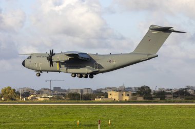 Luqa, Malta - December 14, 2024: Royal Air Force Airbus A400M Atlas C1 (REG: ZM421) landing in the evening for a tech night stop. clipart