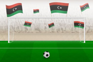 Libya futbol takımı taraftarları stadyumda bayrak sallıyor, futbol maçında penaltı vuruşu kavramı.