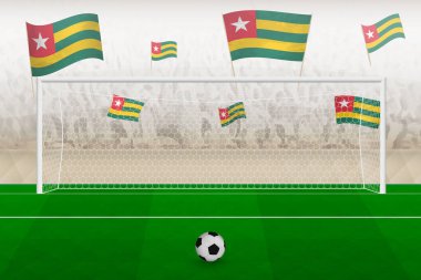 Togo futbol takımı taraftarları stadyumda Togo bayrakları ile tezahürat yapıyor, futbol maçında penaltı vuruşu kavramı.