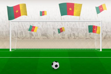 Kamerun futbol takımının taraftarları stadyumda kamerun bayrakları ile tezahürat yapıyor, futbol maçında penaltı vuruşu kavramı.