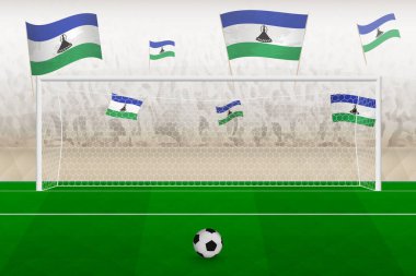 Lesotho futbol takımının taraftarları stadyumda Lesotho bayraklarıyla tezahürat yapıyor, futbol maçında penaltı konsepti..