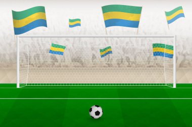 Gabon futbol takımının taraftarları stadyumda bayrak sallıyor, futbol maçında penaltı vuruşu konsepti.