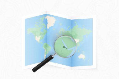 Enlarge Eritrea with a magnifying glass on a folded map of the world.
