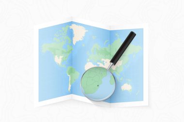 Enlarge Swaziland with a magnifying glass on a folded map of the world.