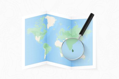 Enlarge Sri Lanka with a magnifying glass on a folded map of the world.