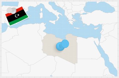 Map of Libya with a pinned blue pin. Pinned flag of Libya.