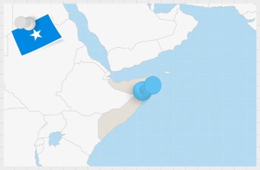 Map of Somalia with a pinned blue pin. Pinned flag of Somalia.