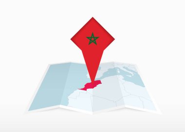 Fas katlanmış bir kağıt haritada ve Fas bayrağıyla tutturulmuş konum işaretleyicisinde resmedilmiştir..