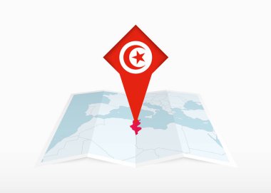 Tunus, katlanmış bir kağıt haritada ve Tunus bayrağıyla tutturulmuş konum işaretleyicisinde resmedilmiştir..