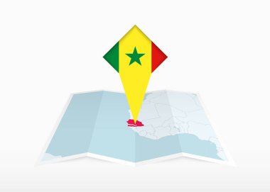 Senegal katlanmış bir kağıt haritada ve Senegal bayrağıyla işaretlenmiş konum işaretleyicisinde tasvir edilir..