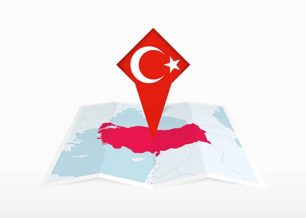 トルコの旗と折り畳まれた紙の地図と固定位置マーカーに描かれています — ストックベクタ
