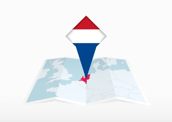 Nizozemsko Vyobrazeno Přeložené Papírové Mapě Připíchnuté Značce Lokality Vlajkou Nizozemska — Stockový vektor