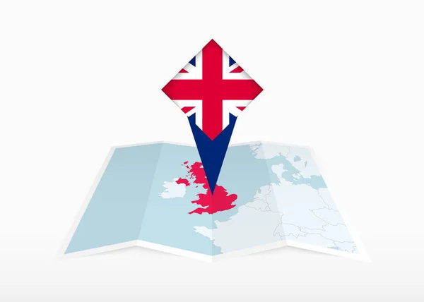 英国被描绘在一张折叠的纸质地图和印有英国国旗的别针定位标识上 — 图库矢量图片