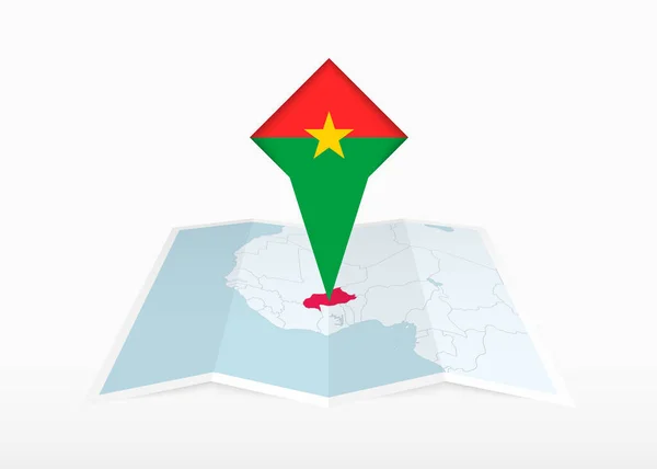 布基纳法索被描绘在一张折叠的纸质地图上 并被钉上印有布基纳法索国旗的位置标识 — 图库矢量图片