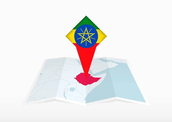 Etiyopya Katlanmış Bir Kağıt Haritada Etiyopya Bayrağıyla Tutturulmuş Konum Işaretleyicisinde — Stok Vektör