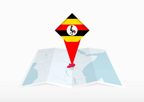 Uganda Avbildad Vikbar Papperskarta Och Fastspikad Plats Markör Med Flagga — Stock vektor