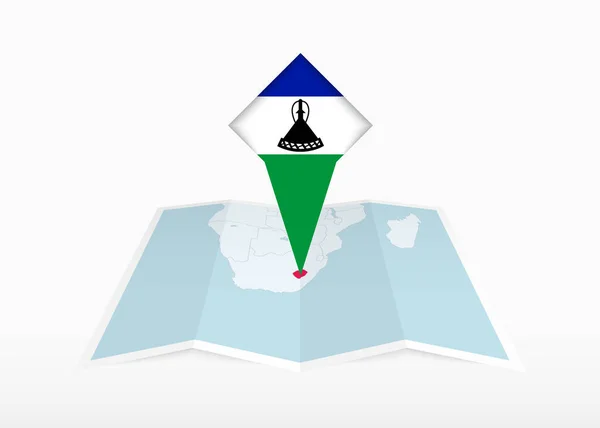 stock vector Lesotho is depicted on a folded paper map and pinned location marker with flag of Lesotho.