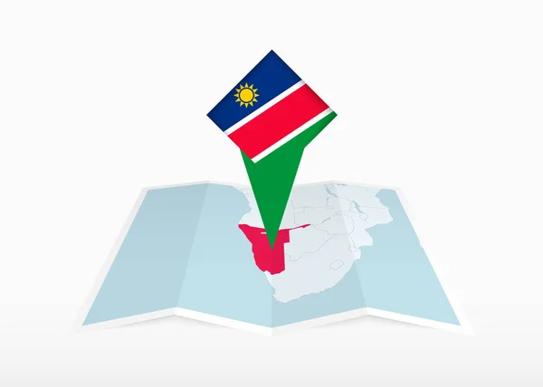 Namibie Vyobrazena Skládané Papírové Mapě Připíchnuté Značce Lokality Vlajkou Namibie — Stockový vektor