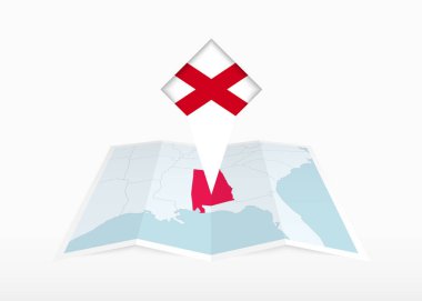 Alabama katlanmış bir kağıt haritada resmedilmiş ve Alabama bayrağıyla işaretlenmiş..