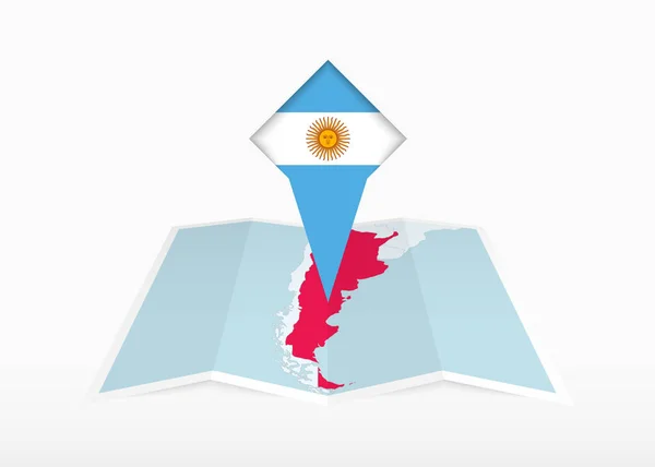 阿根廷被描绘在一张折叠的纸质地图和印有阿根廷国旗的别针定位标识上 — 图库矢量图片