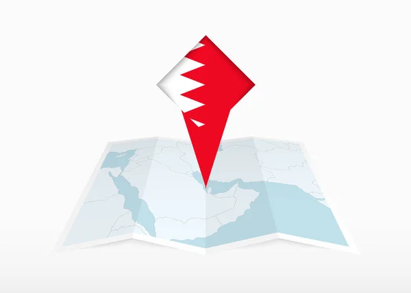 stock vector Bahrain is depicted on a folded paper map and pinned location marker with flag of Bahrain.