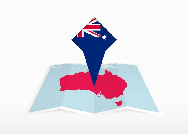 澳大利亚被描绘在一张折叠的纸质地图和印有澳大利亚国旗的别针定位标识上 — 图库矢量图片