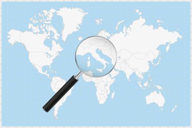 Bir dünya haritasında Vatikan şehrinin haritasını gösteren büyüteç.