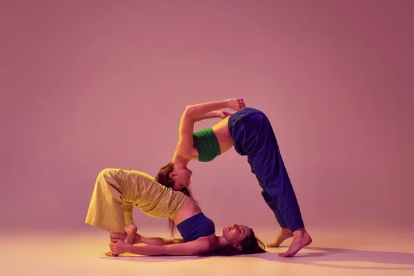 stock image Modern experimental dances. Young stylish fashionable woman dancing contemp isolated over crystal pink background. Concept of modern art, fashion, youth style and creativity