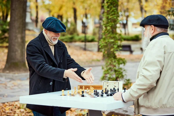 Portrait Two Senior Men Playing Chess Park Daytime Fall Cheerful — Stock Photo, Image