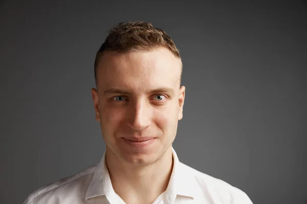 stock image Close-up portrait of young businessman attentively looking at camera, posing isolated over grey studio background. Concept of mens health, lifestyle, fashion, emotions, well-being. Copy space for ad