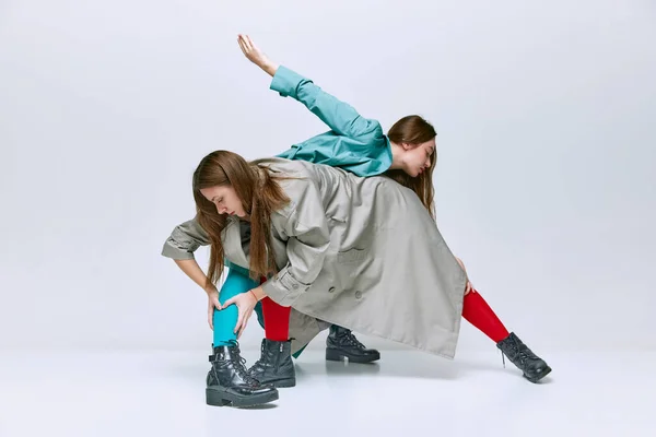 Portrait Two Young Women Bright Red Blue Tights Coat Posing — Foto de Stock