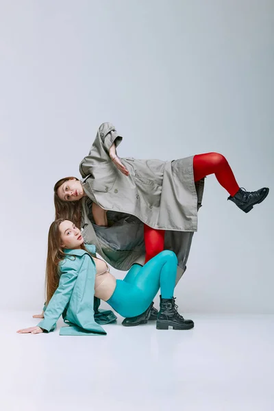 Portrait Two Young Women Bright Red Blue Tights Coat Posing — Stock fotografie